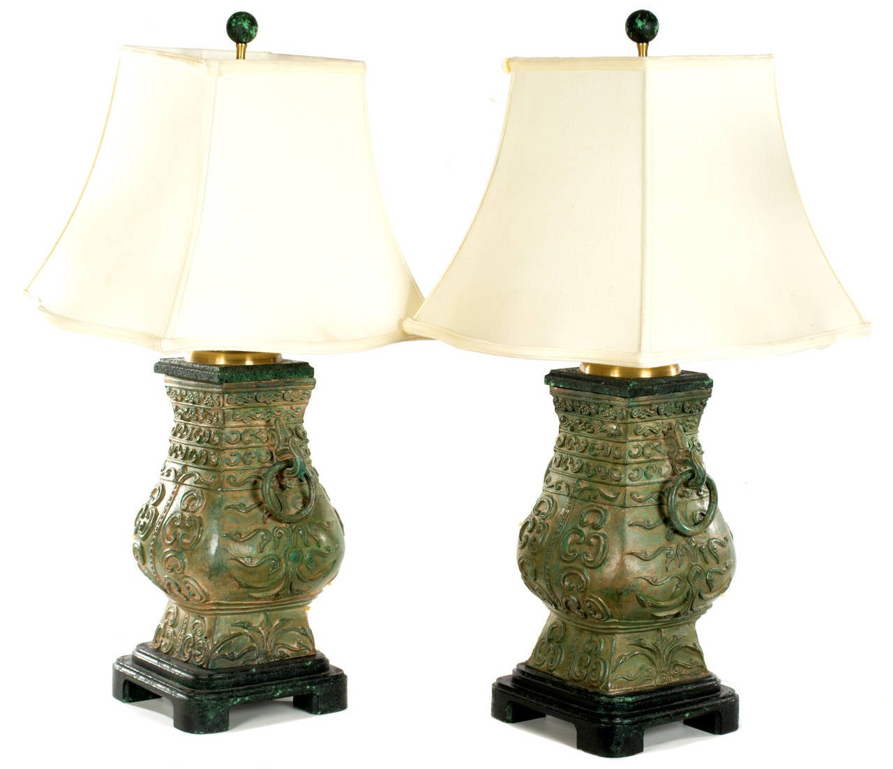 Two midcentury lamps in the shape of ancient Chinese temple urns with giltwood tops and ebonized wood pedestals.