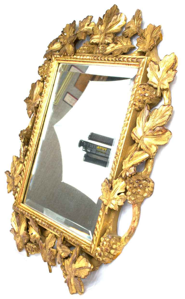 Carved Italian Gilt And Bevelled Grapevine Mirror For Sale