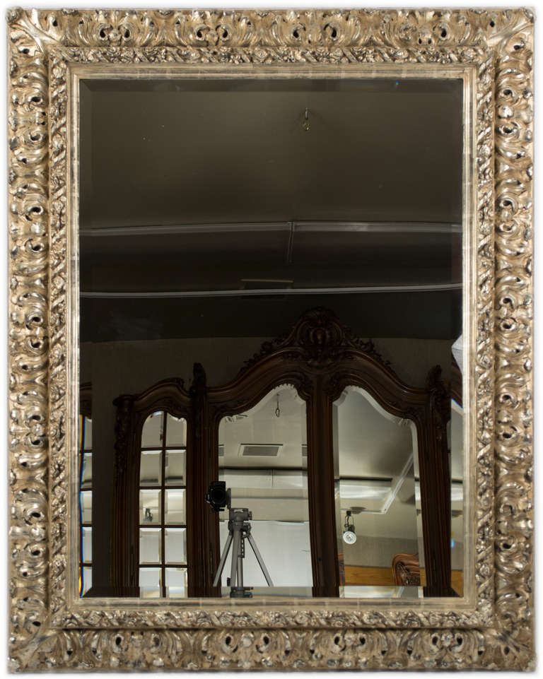 This very large, Baroque style mirror features two layers of pierced acanthus leaves that have been 