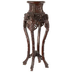 A captured-top Chinese rosewood pedestal table