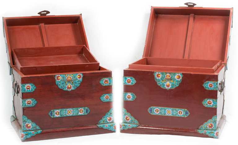 This pair of chests was made in China of beautifully preserved mahogany and cloisonné strapwork.