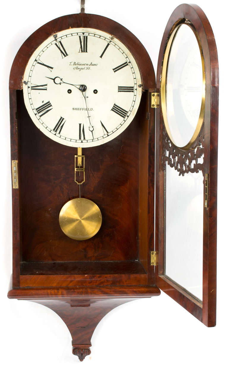 In fine working condition, this wall clock made of walnut and brass was made in England by the Sheffield clockmaker 