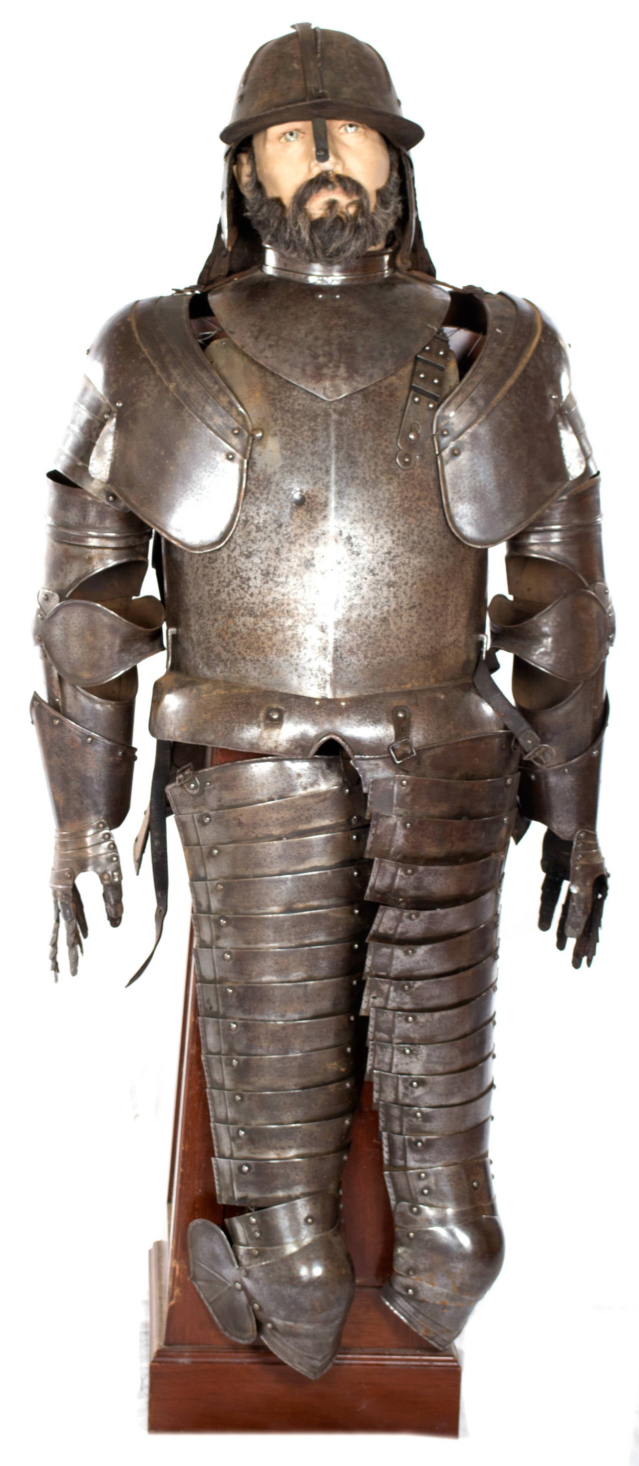 A continental suit of armor with helmet to be worn by horse rider made during the last half of the sixteenth century, and placed on a purpose-built mahogany stand with mannequin head.