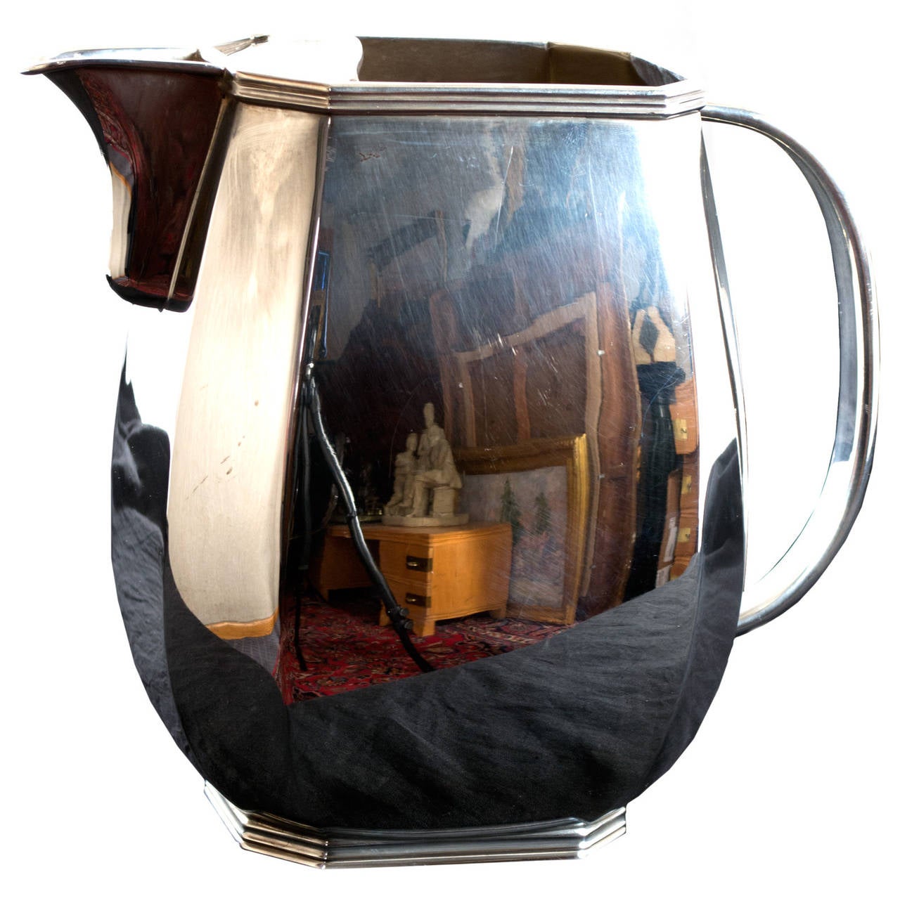 A late-nineteenth-century sterling silver pitcher made in England with markings on the bottom.