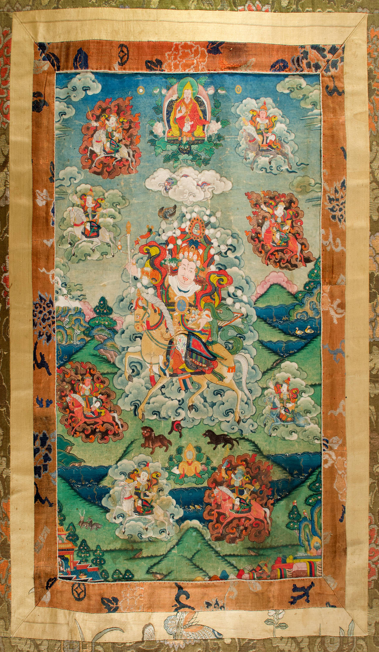 This nineteenth-century painted Tibetan scroll, known as a thangka, mounted on layers of embroidered silk, features the Great Golden Vaishravana,  the dispenser or riches, god of wealth, king of the yakshas, and guardian of the North. He is