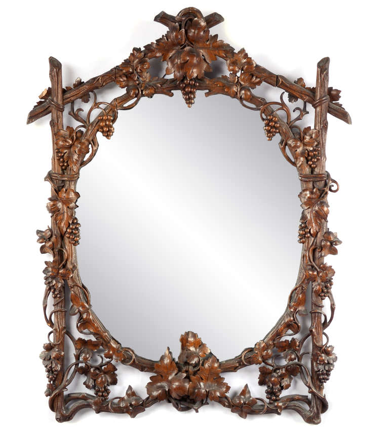 This nineteenth-century mirror is expertly carved with extremely realistic grape vines, leaves, and clusters.