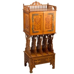 An Arts & Crafts Carved And Decorated Music Cabinet