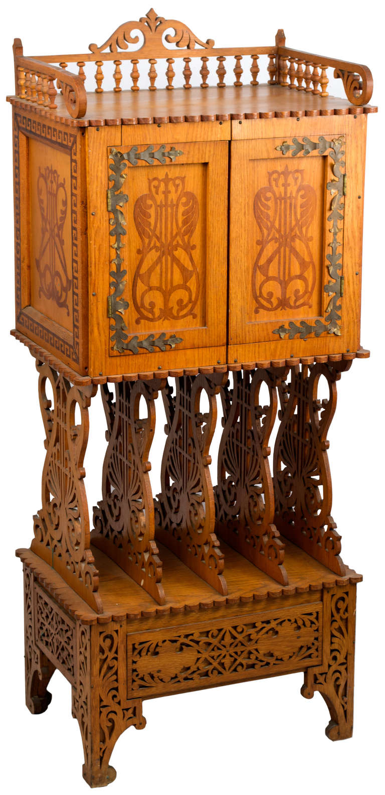An Arts & Crafts Carved And Decorated Music Cabinet