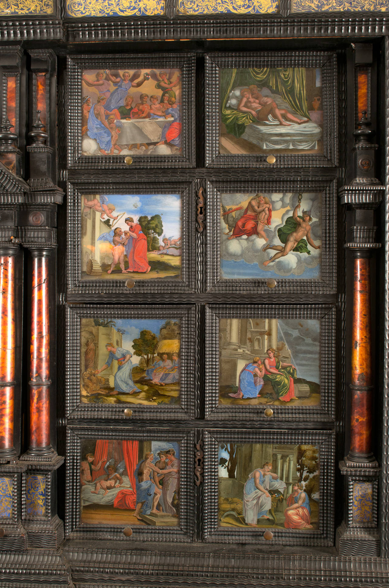 A seventeenth-century princely cabinet-on-stand with twenty eight  glass paintings in bright colors;  eight of the Italian countryside found behind the central door, and the remaining nineteen paintings — fronting the drawers of the cabinet —