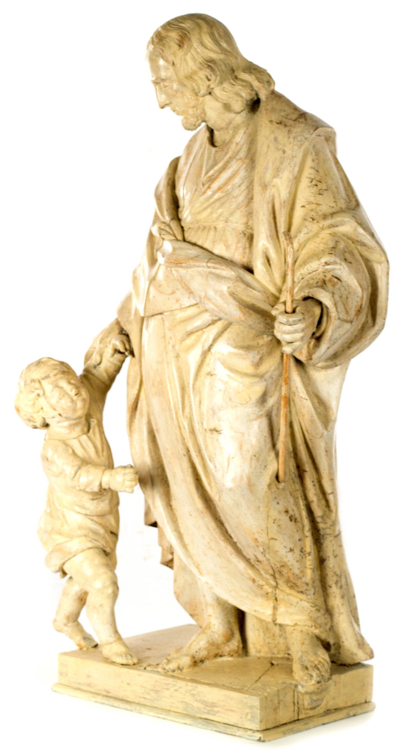 Holding a shepherd's crook in his left hand and comforting a child with his right, this nineteenth-century Italian statue depicts Christ as the Good Shepherd. The work is beautifully sculpted, using traditional techniques and materials dating from