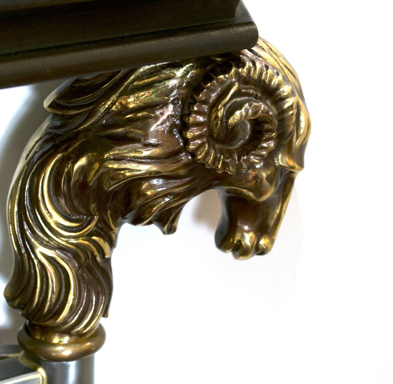 With marble top held by the heads of four rams and the front central panel featuring a hand-wrought laurel crown and two crossing spears, this console table was made in mid-century Italy.