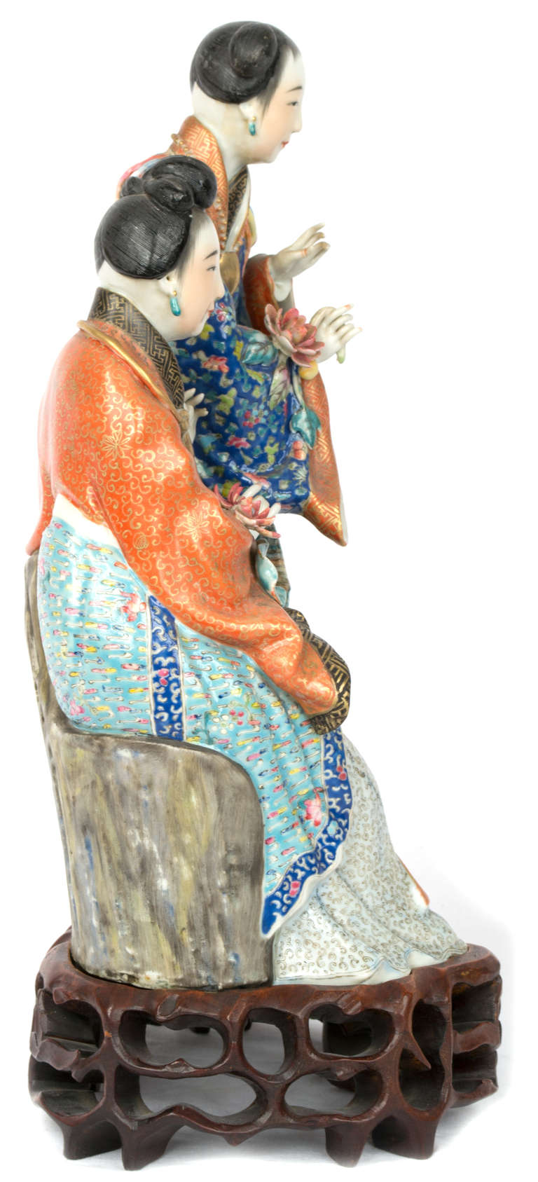 REPUBLIC PERIOD (1912-49), CAO MING JI ZAO IMPRESSED MARK 
A standing lady with a further lady seated on a tree trunk, dressed in brightly painted, polychromed robes with floral decoration and holding lotus and fruiting branches