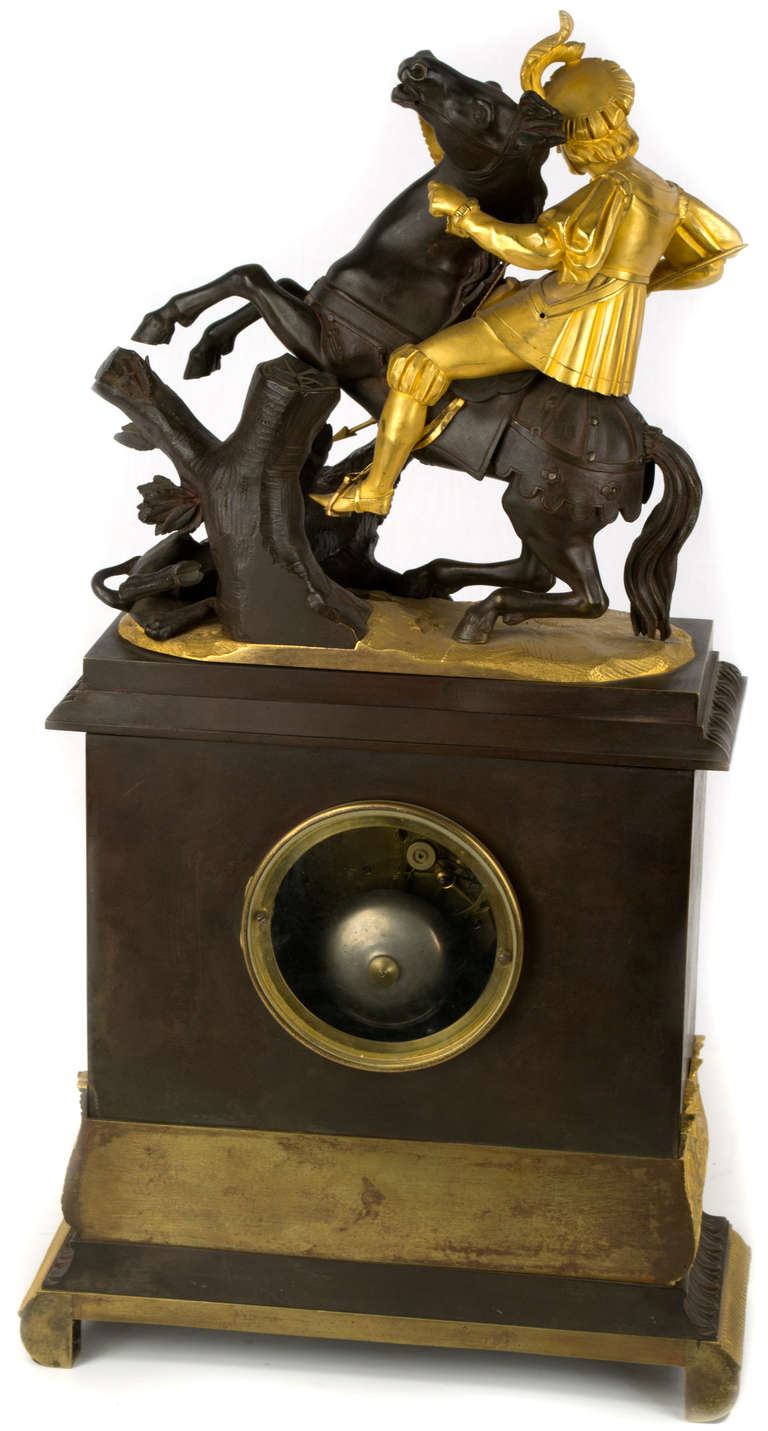 A gilt and sculpted French mantle clock with a large, exceptionally well realized sculpture of a boar hunt, in the pose of St. George and the Dragon, from the second quarter of the nineteenth-century.