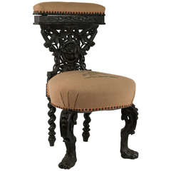 Antique Ebonized Smoking Chair with Elaborate Carving
