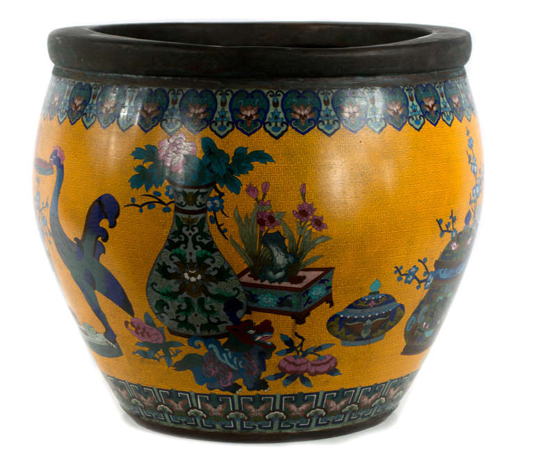 In bright yellows, greens, pinks, and whites, this large bowl features detailed cloisonné depictions of the eighteen sacred gifts.
