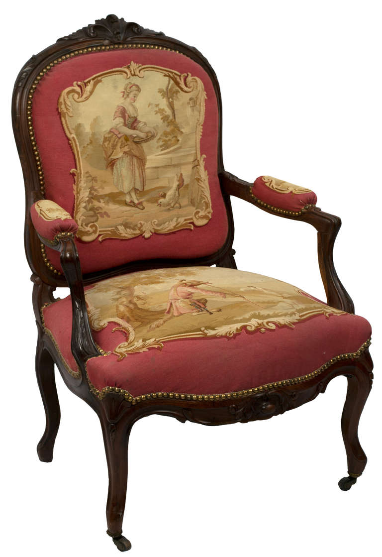 Luxuriously carved in rosewood, this set — a large sofa, four arm chairs, and two side chairs — is upholstered with a Aubusson tapestry depictions of the fables of La Fontaine. 

Side Chair: 38.5