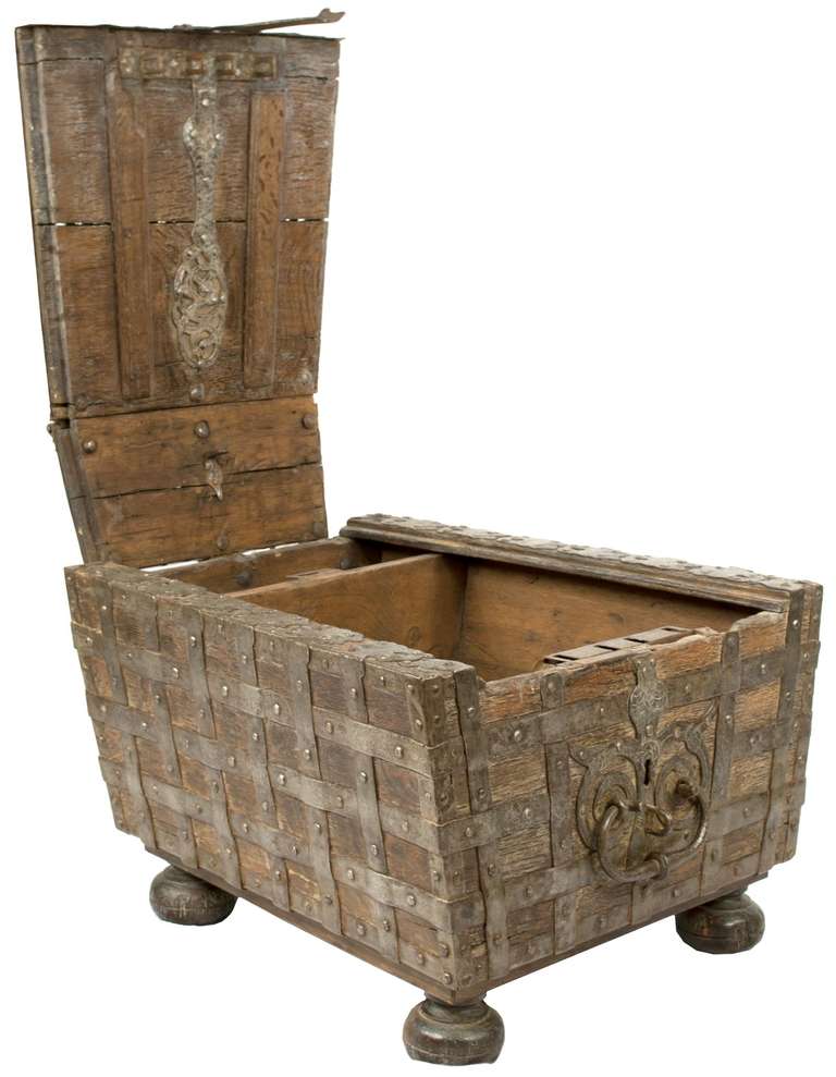 This unusual strong box (i.e. safe) opens to reveal two compartments, a decorative interior, double-hinged lid, and comes with a working key and lock. The piece could be used as a coffee or side table.