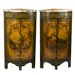 A pair of green Venetian corner cabinets