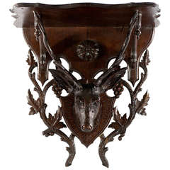 Antique A Black Forest bracket shelf with stags head