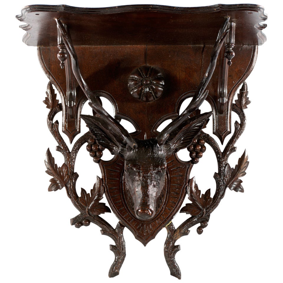 A Black Forest bracket shelf with stags head