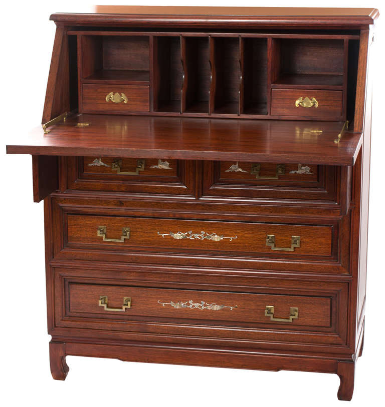A French secretaire in mahogany richly inlaid with mother of pearl. The top features inlay of two exotic birds resting on the branch of a blossoming cherry tree branch. The front of each of the four exterior drawers also feature extensive,