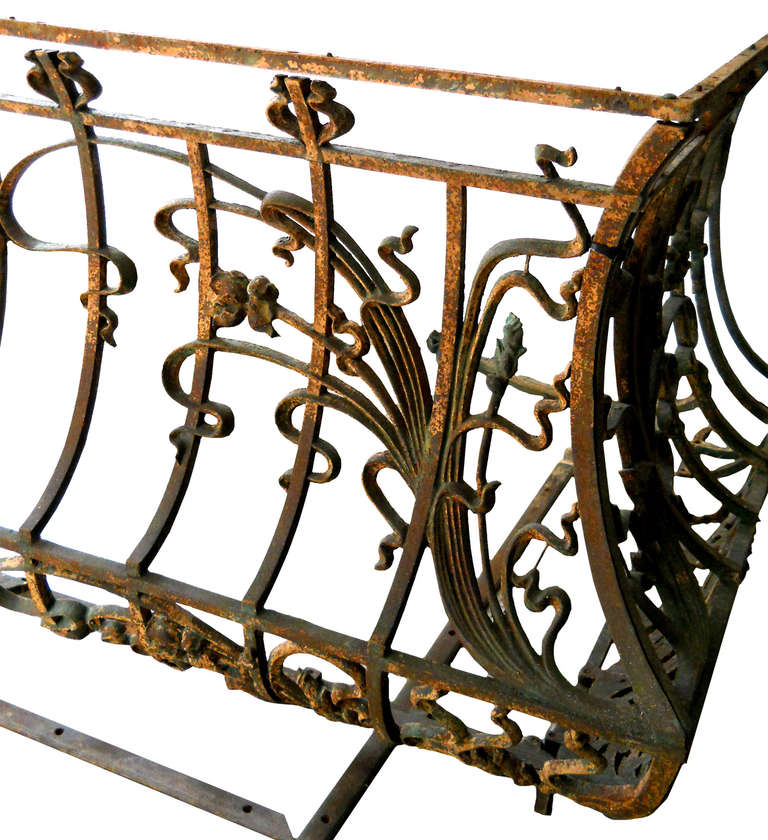 Two monumental wrought iron bannisters featuring representations of sinuous leaves and reeds weaving in and out of bars. The bannisters were taken from the exterior of a French period home, now demolished.