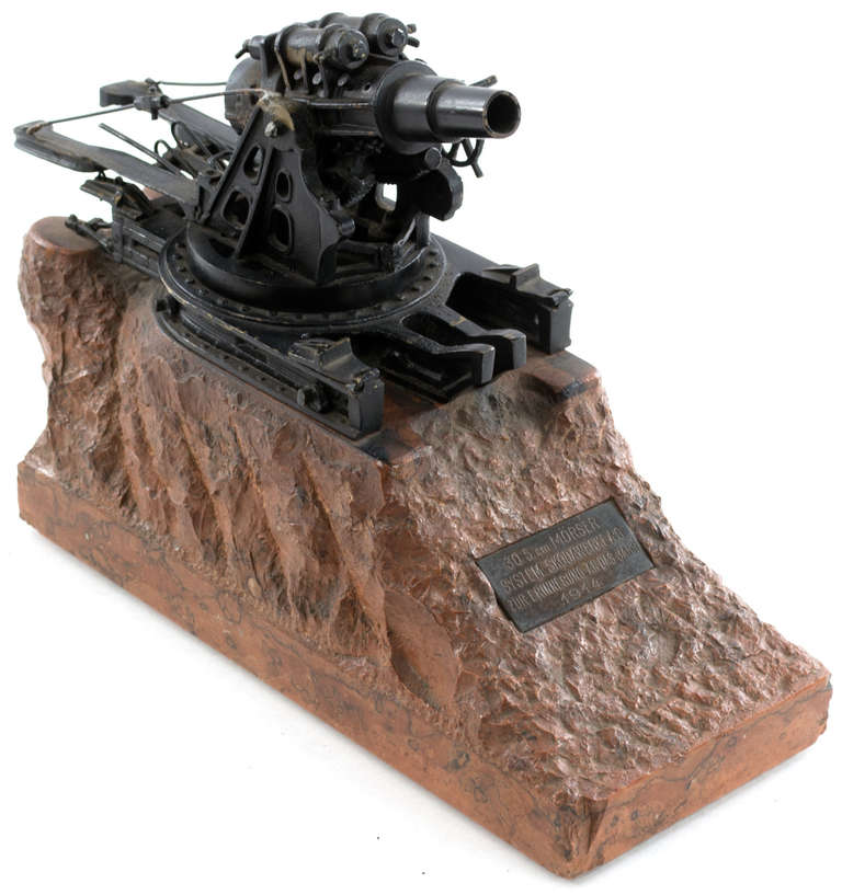 A beautifully sculpted reproduction of a German, WWI era gun in bronze and marble. The bronze plaque reads: 