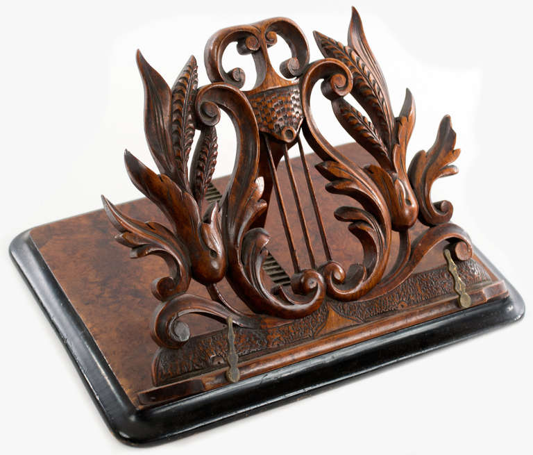 Carved in the shape of Apollo's lyre and ornamented with acanthus leaves, strapwork, s-scrolls and c-scrolls, this beautiful music/book stand, which can be adjusted a more than a dozen angles, is meant to sit on a flat surface.