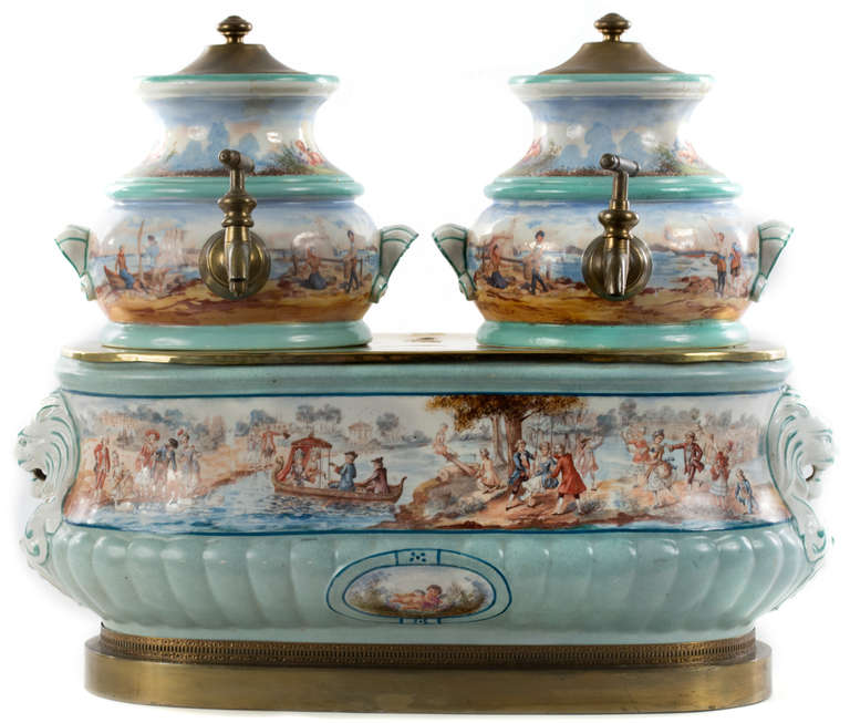 A beautifully painted Sévres style porcelain and brass, French coffee and chocolate dispenser combined with warmer, featuring several multi-figural scenes of village and noble country life during the late 18th century.