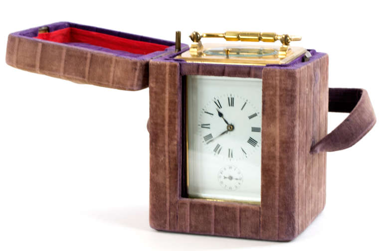 In fine working condition and in its original case, this brass and leaded-glass carriage clock, features a minute repeater, an alarm mechanism, and a 