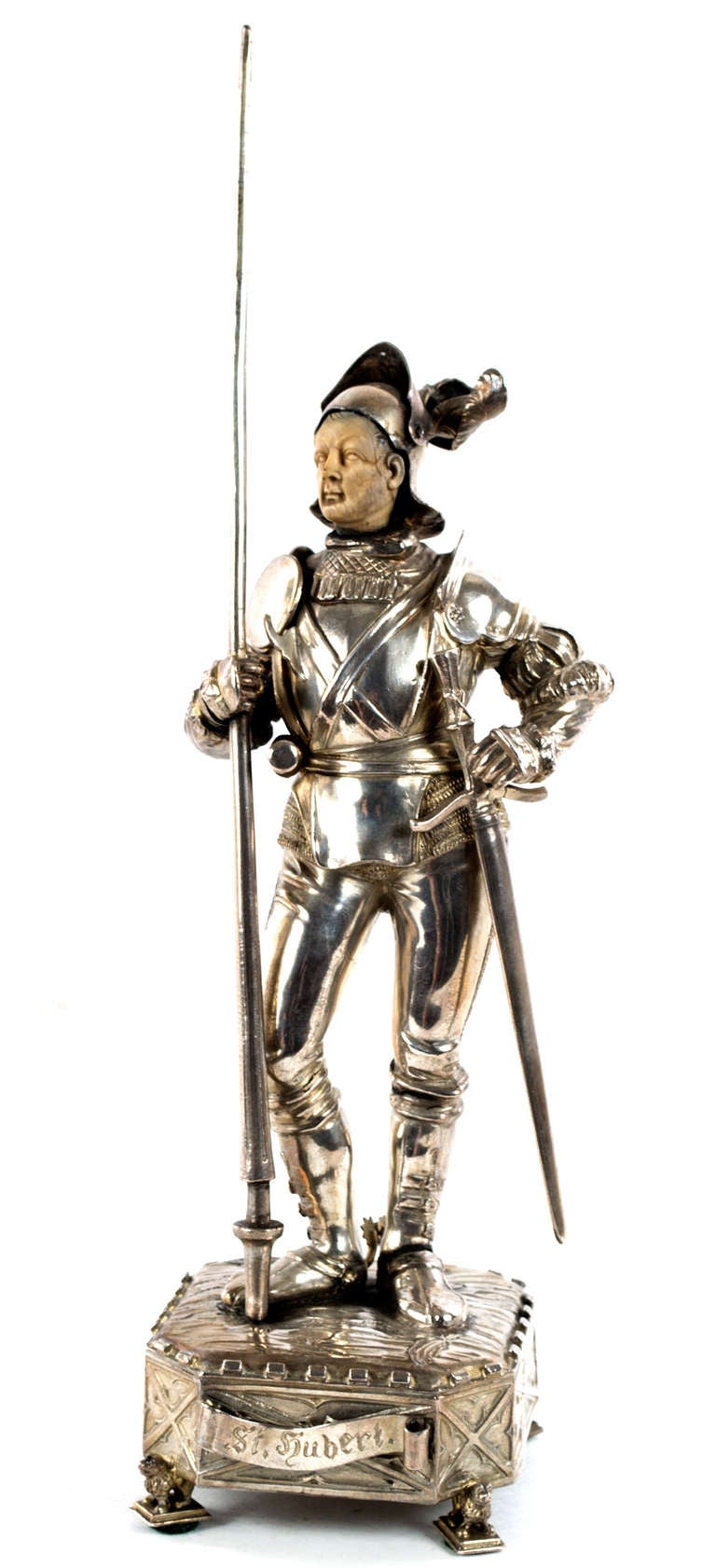 The work of a highly skilled sculptor, this sterling silver statue of St. Hubert, Patron Saint of Hunters, is dressed in a romanticized suit of armor, holding a tall lance, and standing on a pedestal resting on four lions.