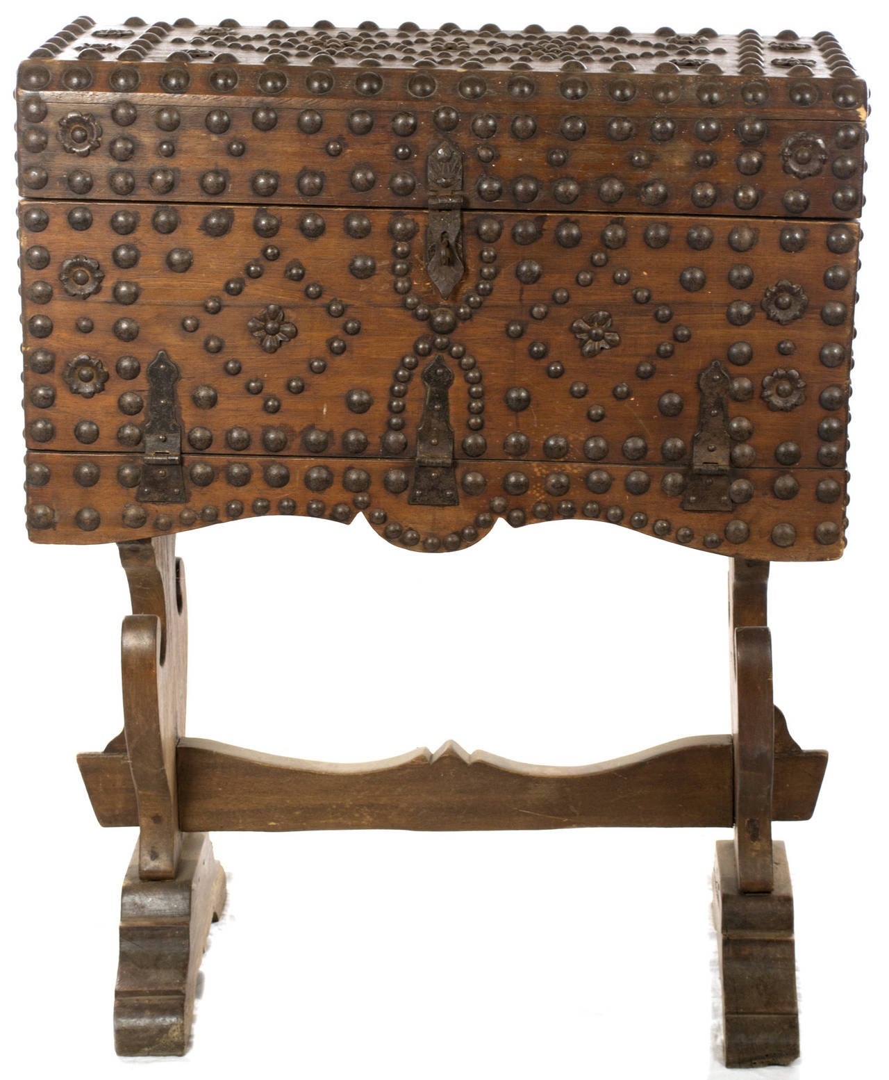 An Iberian oak box on matching stand inlaid with dozens of iron studs in geometric, Hispano-Moresque patterns. The chest opens upwards to reveal large, iron-lined compartment.