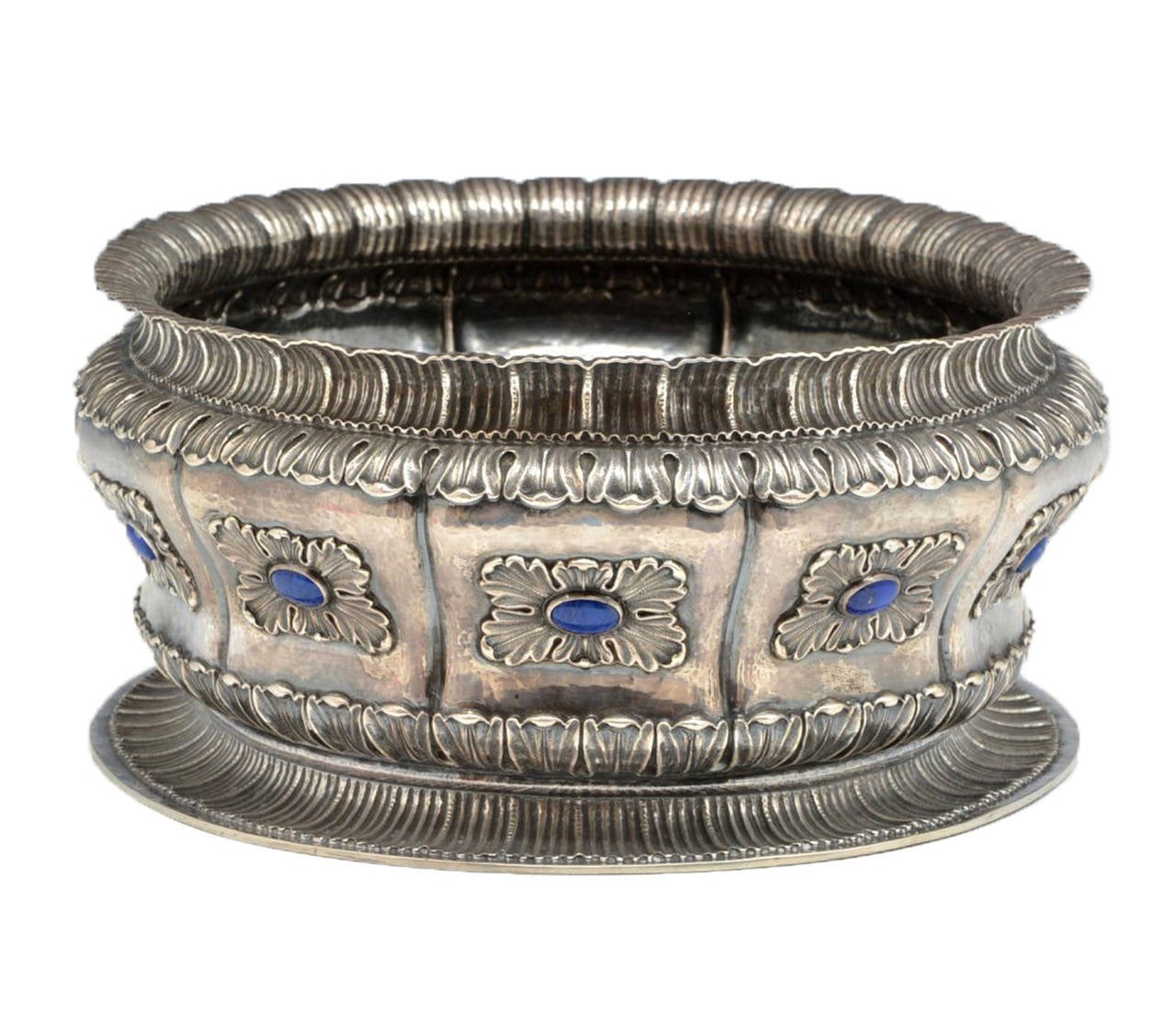 Decadently hand chased and fitted with several large lapis-lazuli stones, this Buccellati bowl is made for holding and displaying fine wines and champagnes.