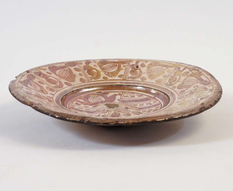 Wonderful early, circa 1550 Spanish Hispano-Moresque copper lustre pottery charger of large size having unique panelled and folliate pattern; likely of Manises production. Condition is considered good as pictured having typical glaze wear in the