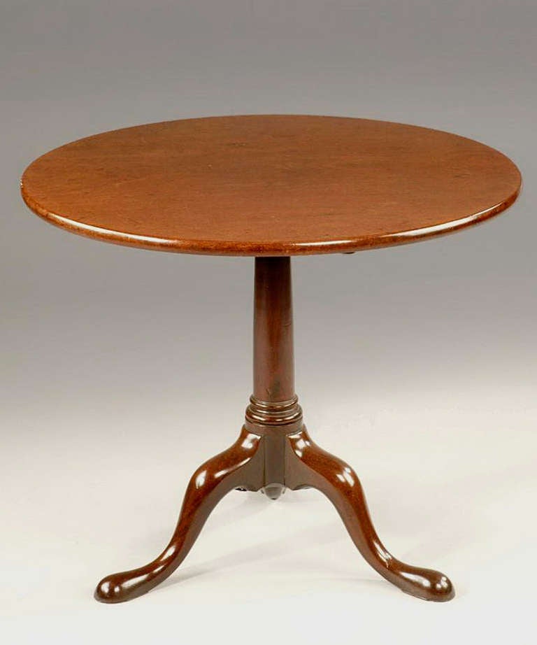 A Georgian mahogany tilt-top tripod table; having a gun barrel stem and raised on cabriole legs terminating in pad feet.