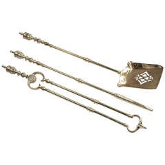 An Antique Set of Brass Fire Irons