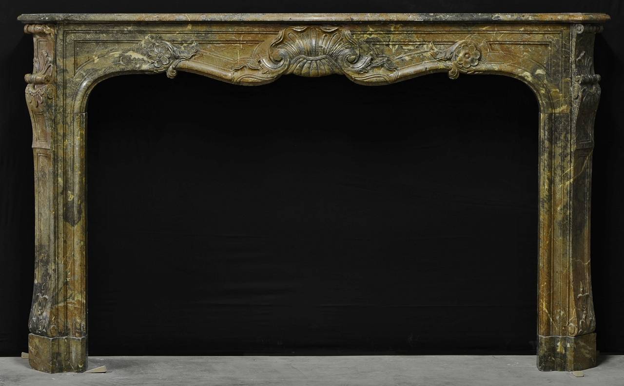 Large 18th century French Louis XIV mantelpiece which is made from Rouge Royal. 
This elegant fireplace comes from the Paris region, it still has its original patina.

Inside measurements: 42.3 x 64.2 inch (height x width).

Non original