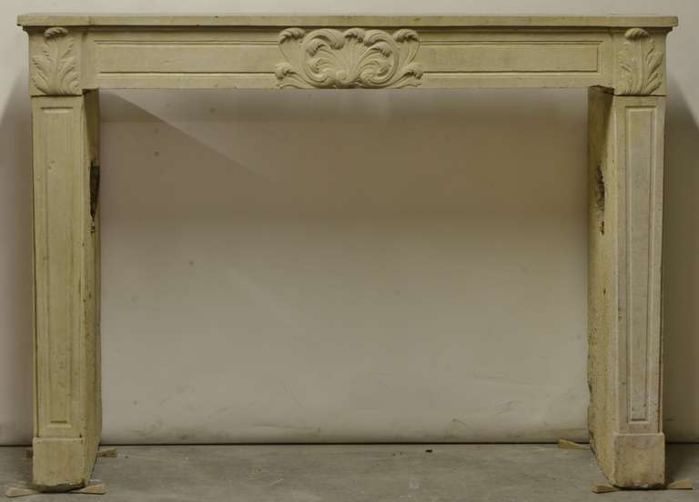19th century Louis XVI limestone fireplace. Opening measurements: 37.8 x 48.8 inch (height x width).