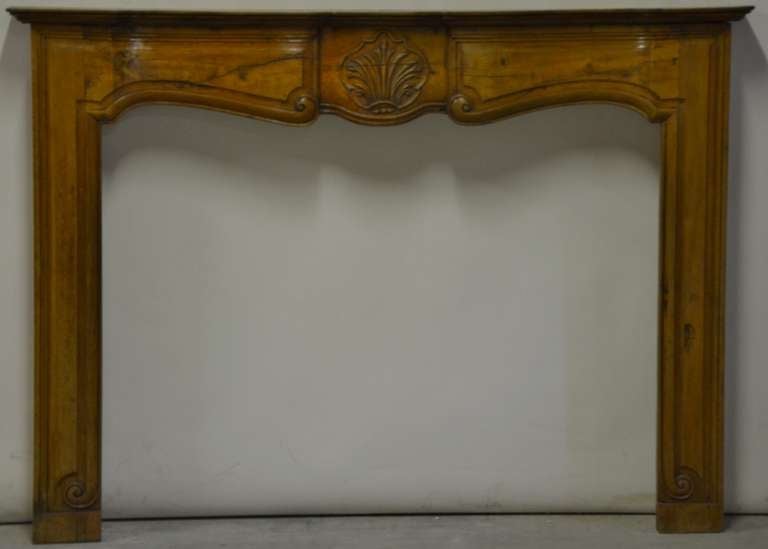 Decorative French, 18th century cherrywood fireplace.

Opening measurements: 32.2 x 42.1 inch (height x width).