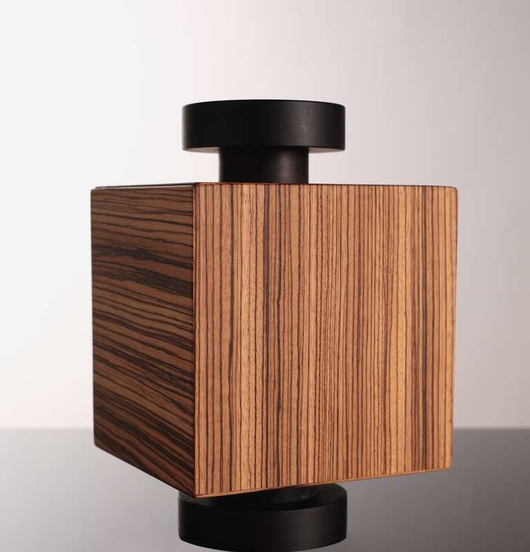 Wooden box of the 'Secret Boxes' series. Limited edition of 99. Birch plywood structure covered with three layers of zebrawood. Knob and base of solid black ebony. Wax finish.