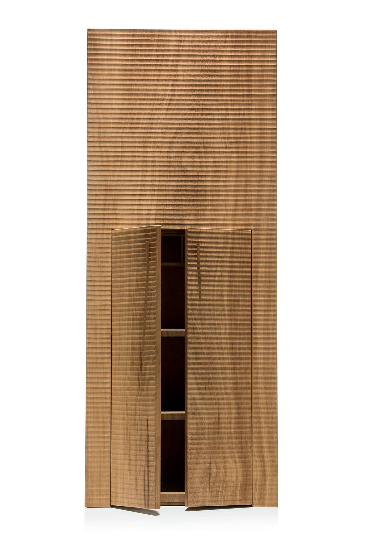 Large sculptural wooden cabinet 'Petra' in Iroko wood carved by gauge. Two doors and inside two shelves and a row of square compartments.