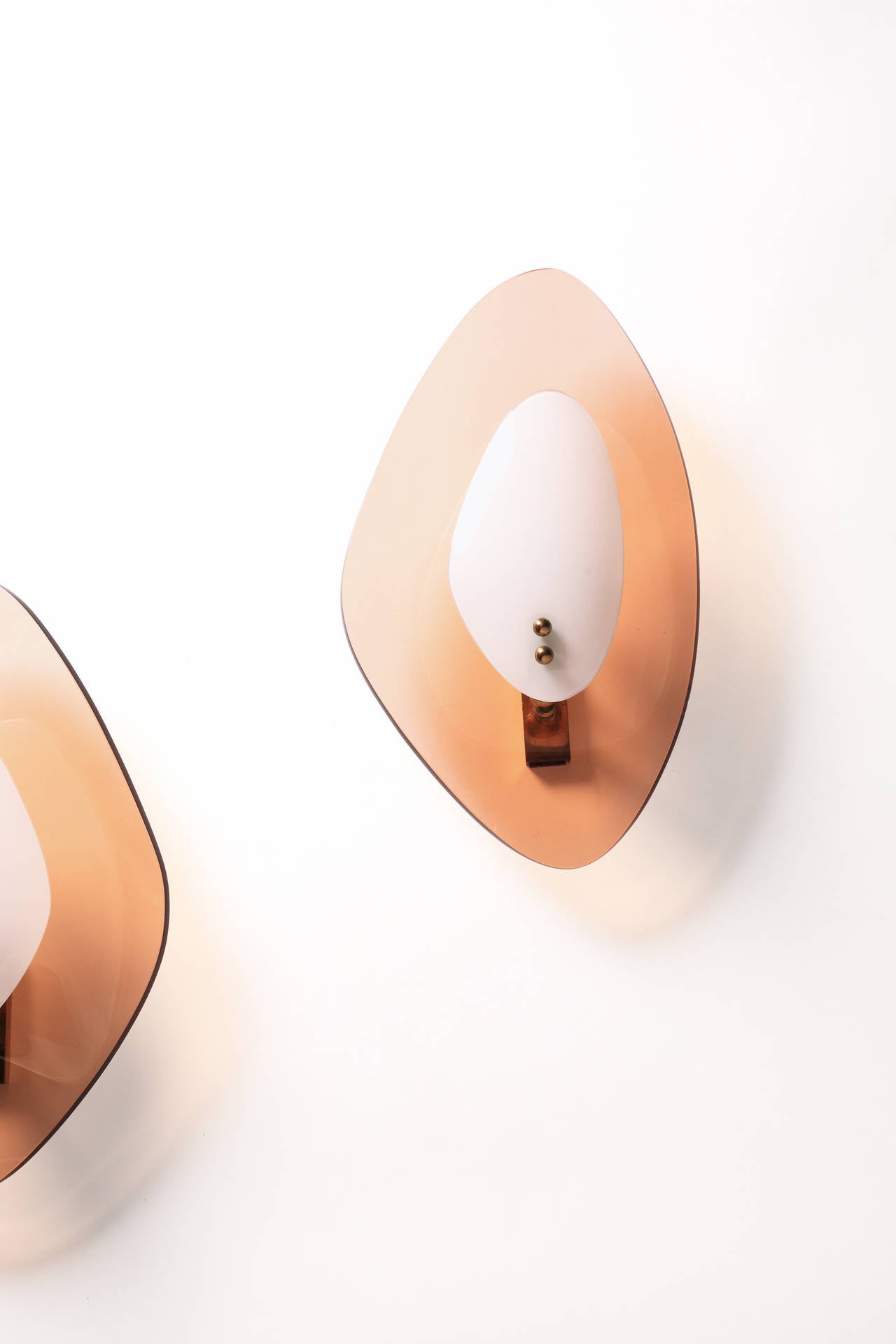 Pair of wall lights in clear and opaline curved glass mounted on brass fittings.
Producer: Cristal Art