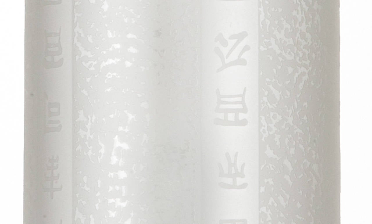 A suspension light with cylindrical glass element etched with oriental writing symbols and a brass metal structure.