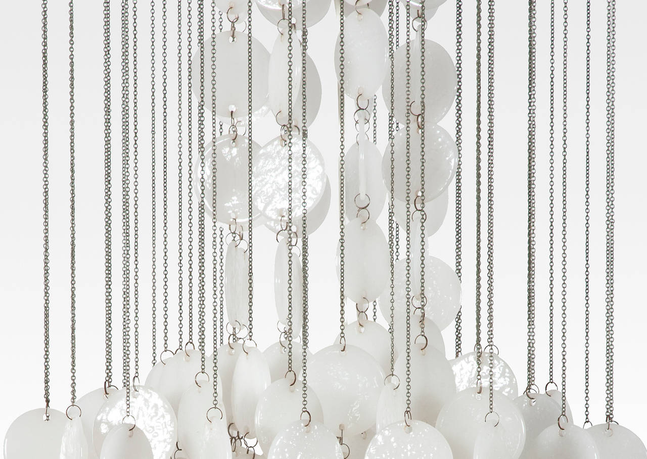 1970s Murano chandelier with opaline glass discs suspended on chains.