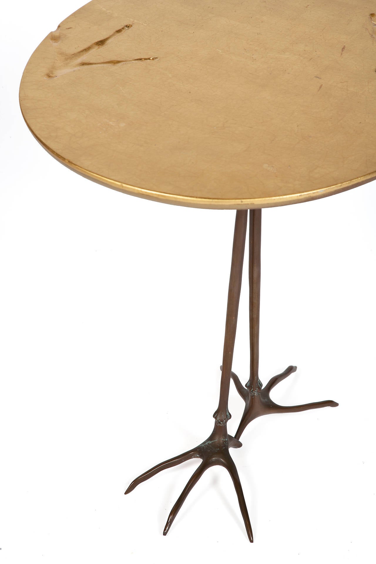 Surrealist sculptural oval table with a gold leafed top on bronze legs.
From the 1936 model by Meret Oppenheim, it was produced by Gavina as part of the 'Ultramobile' collection.