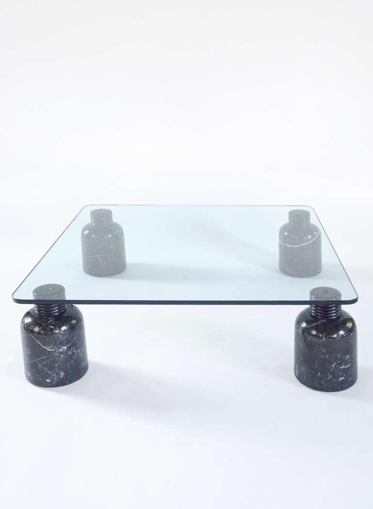 Coffee table by Hans Von Klier produced by Fucina for Skypper.
The set of four legs are in 'Nero Marquina' marble and shaped dark wood 
cappings. 
The factory chart shows the various possibilities for the size and shape of the glass top.