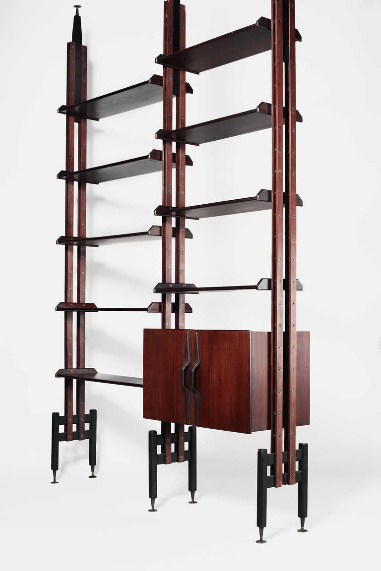 Adjustable freestanding bookshelf system in dark woods | Storage cabinet with leather handles | Brass fittings
