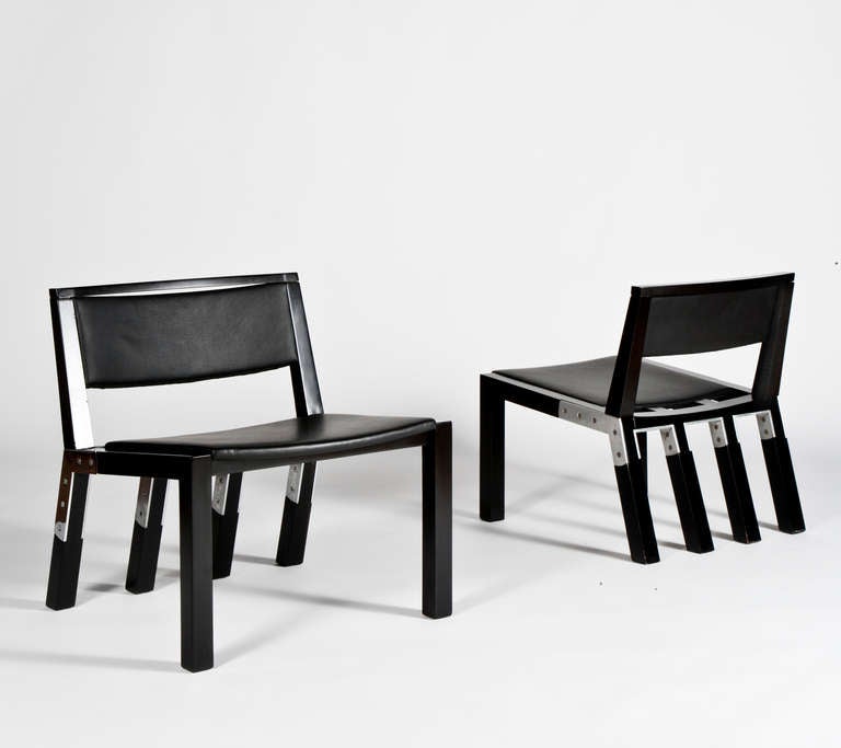 Pair of chairs in ebonized wood, chrome plated metal and black leather.

These chairs are  prototypes and differ in size. These pieces were commissioned for  the seating areas  of the Louvre Museum in Paris and produced by (Osvaldo Borsani) TECNO.