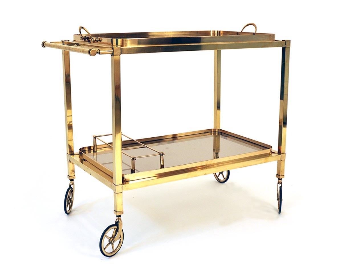This serving trolley comes from France and it was designed in 1950.
The serving trolley is made out of brass and the two glass areas are made out of insulating glass. The upper tablet is removable.