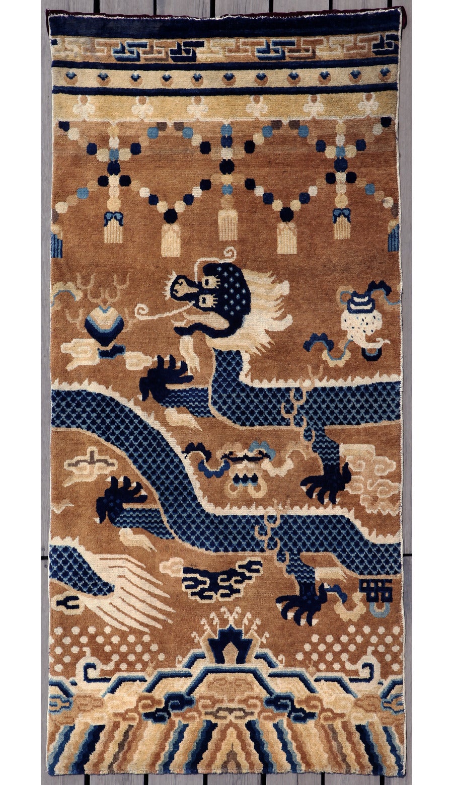 This is a Classic antique Ningxia pillar rug from China with the depiction of a five-clawed dragon playing with the flaming pearl.
 
For centuries, Ningxia rugs have been praised for the quality of their wool, design and colors. Collectors of